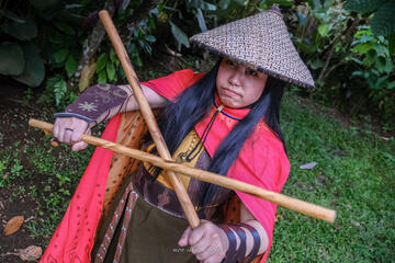 Pōhutukaryl Cosplay as Princess Raya, steely eyed, holding arnis sticks Pōhutukaryl Cosplay as Princess Raya, steely eyed, holding arnis sticks