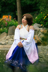 Pōhutukaryl Cosplay as Yuna from Final Fantasy X, looking thoughtfully into the distance